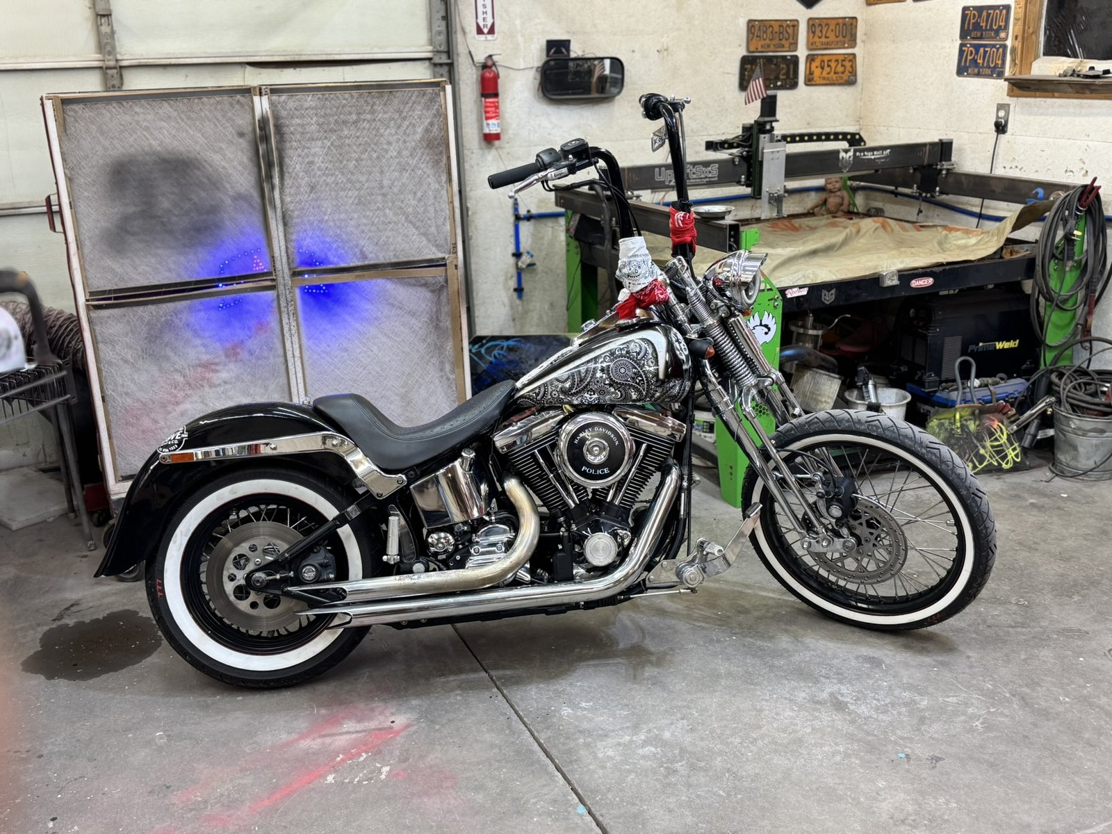 Tainted Love, the shop's own '97 FXSTS Springer, with paisley tank in silver leaf and portrait detail