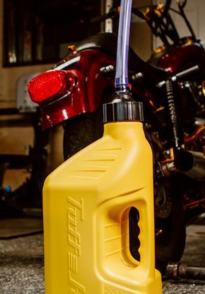 Yellow Tuff Jug fuel container in a motorcycle garage