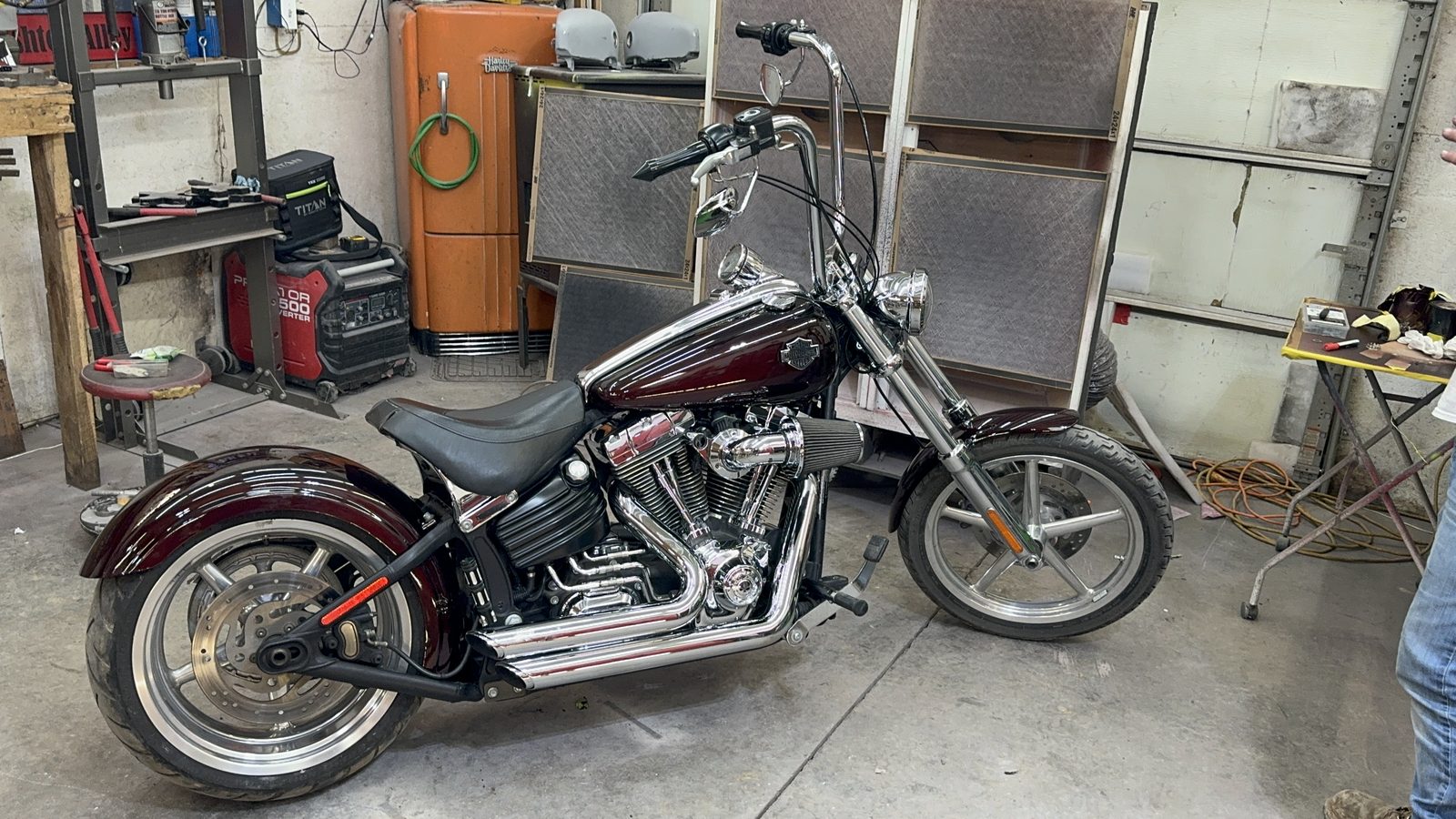 Custom maroon and black Harley-Davidson Softail with chrome engine, finished in the shop