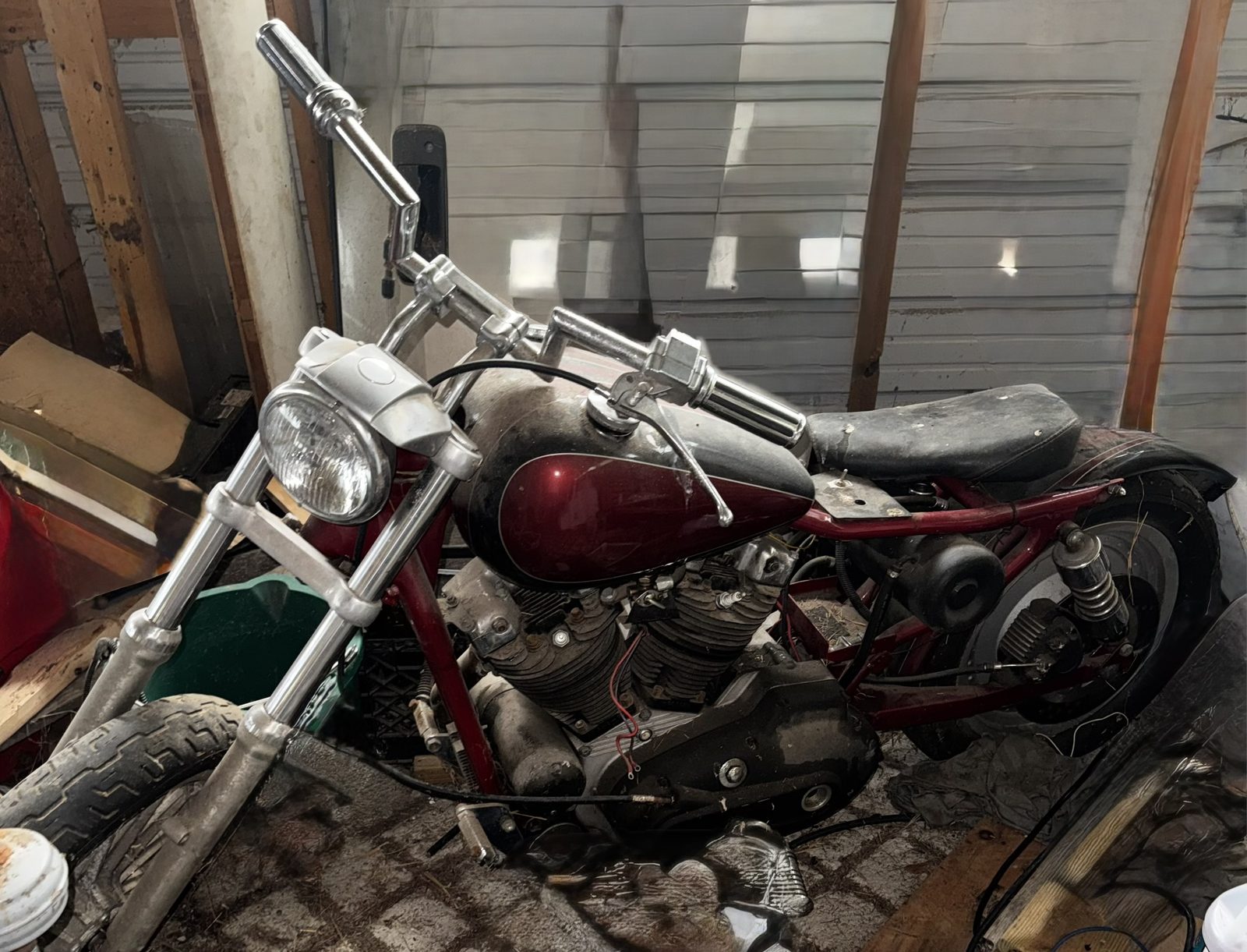 Unrestored vintage motorcycle project with faded paint and worn parts, before restoration work begins